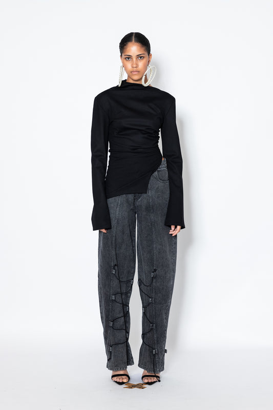 Model wears Jade Cropper Asymmetric Top With Slit in black featuring high neck asymmetric hem and slit front detail