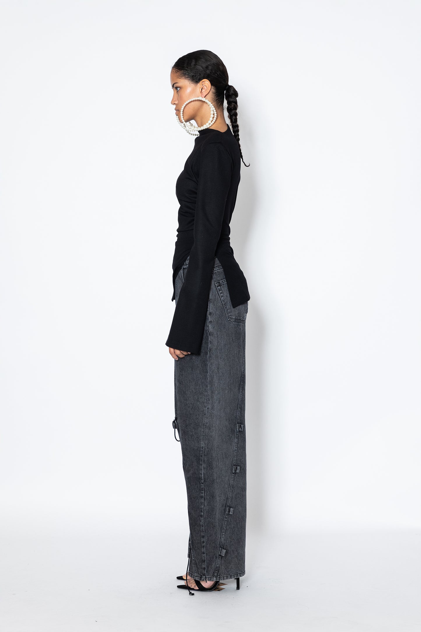 Side view of Jade Cropper Asymmetric Top With Slit black long sleeves fitted cut asymmetric hem with slit detail