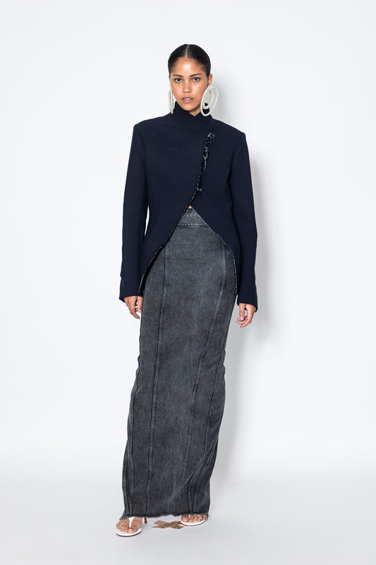 model wearing Jade Cropper navy garment with asymmetrical cut raw edges long sleeves and collar front view