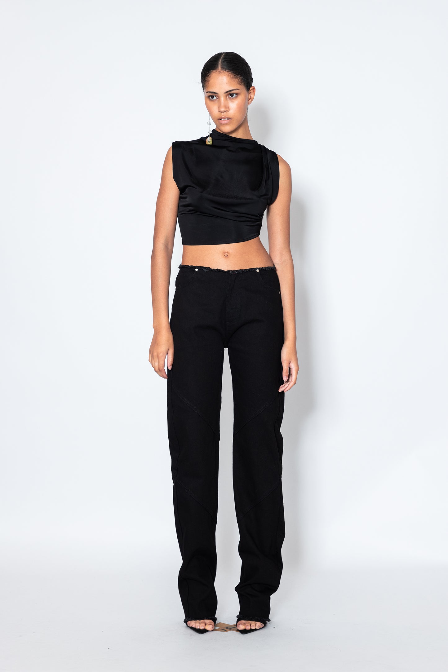 Model wears Jade Cropper Black Raw Hem Jeans front view in black with high rise wide leg and raw hem stitch detailing