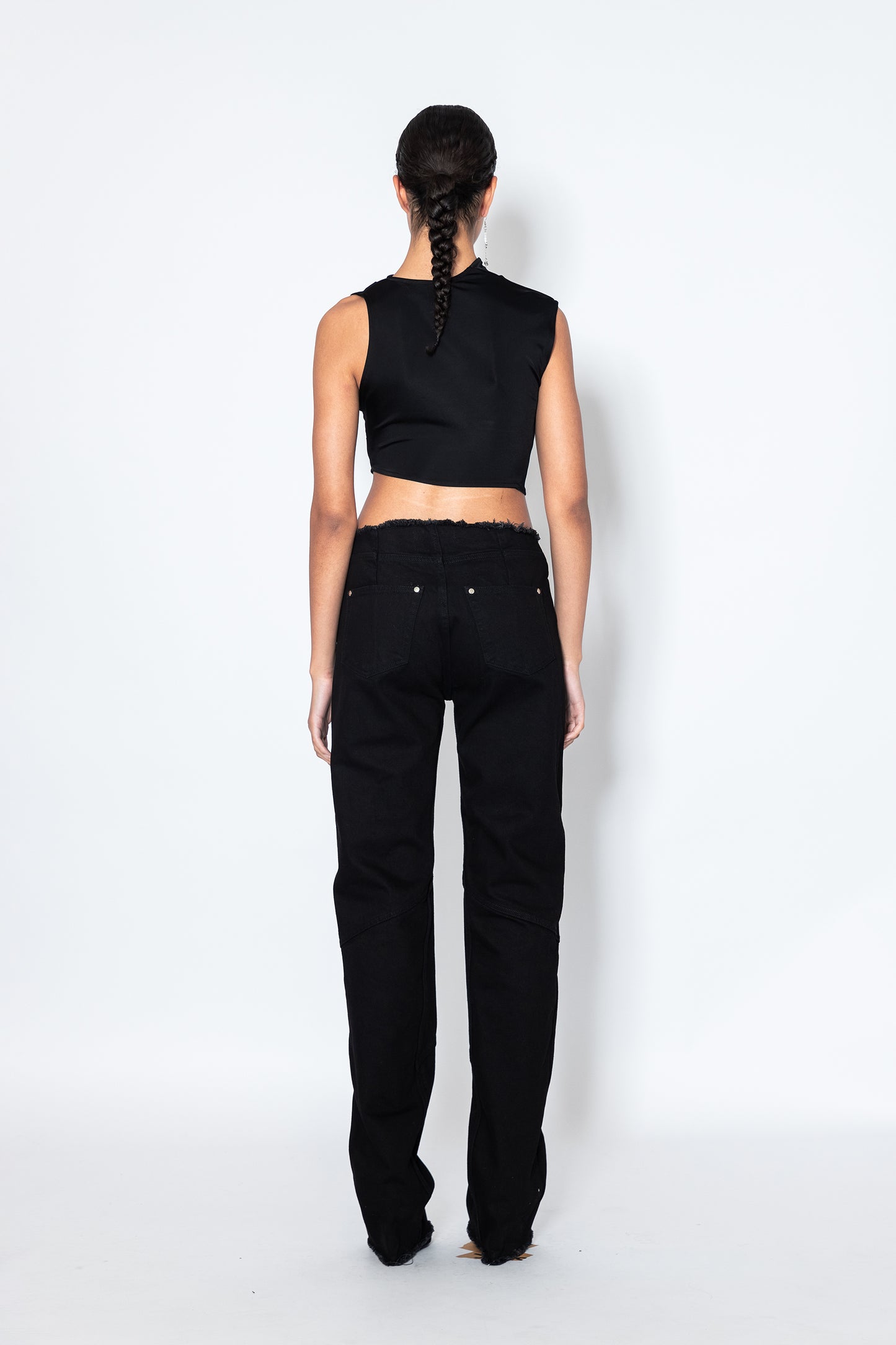 Model shows Jade Cropper Black Raw Hem Jeans back in black with straight leg raw edge and five-pocket high rise design