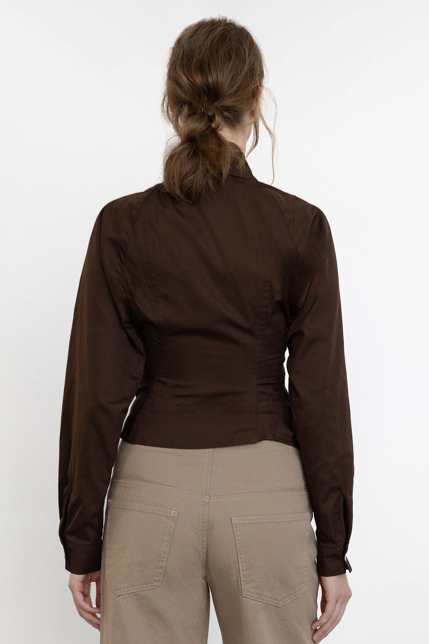 Jade Cropper asymmetric shirt brown back view fitted construction with asymmetric hem long sleeves and button detail