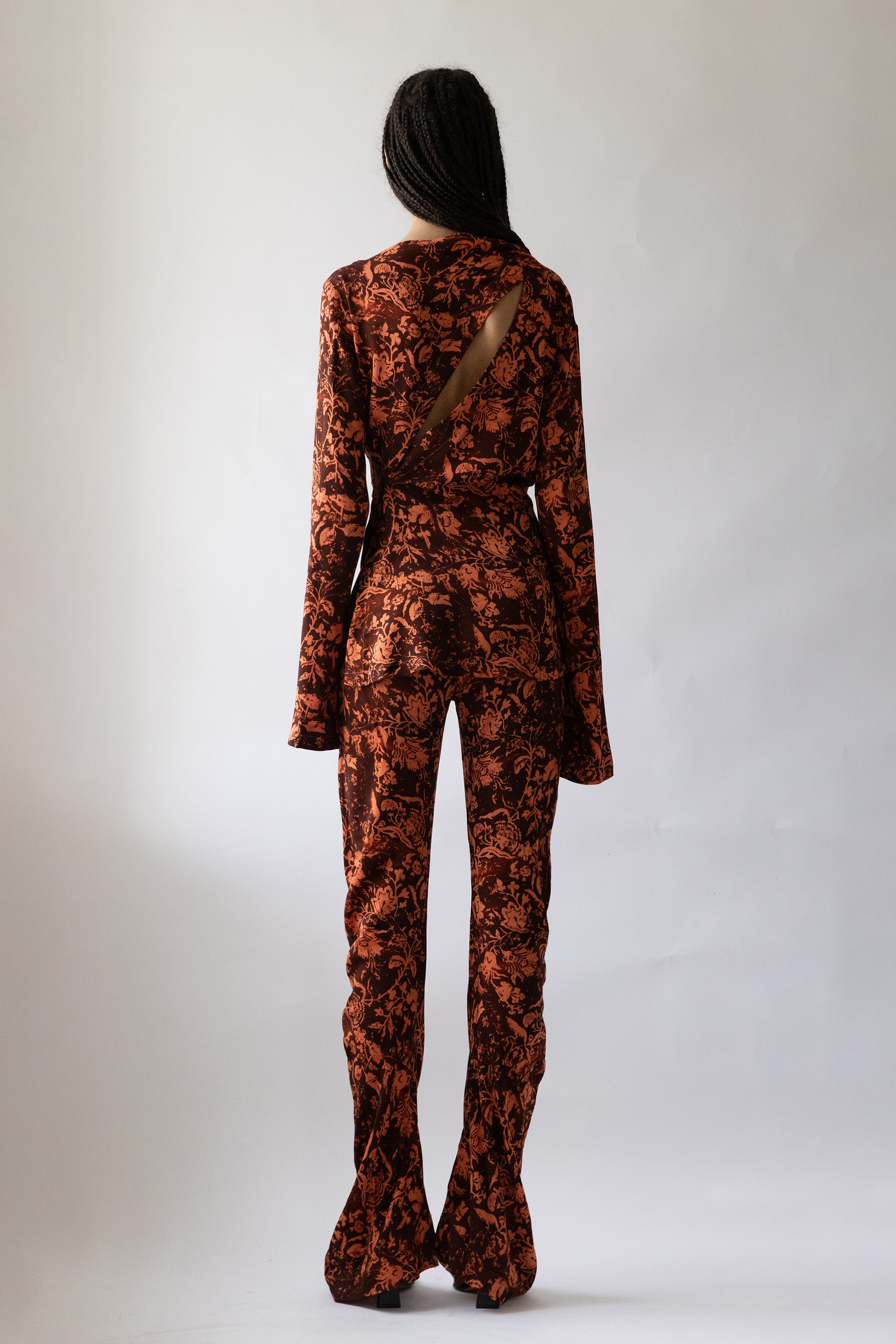 model wearing Jade Cropper garment rear view showing fabric flow and back silhouette