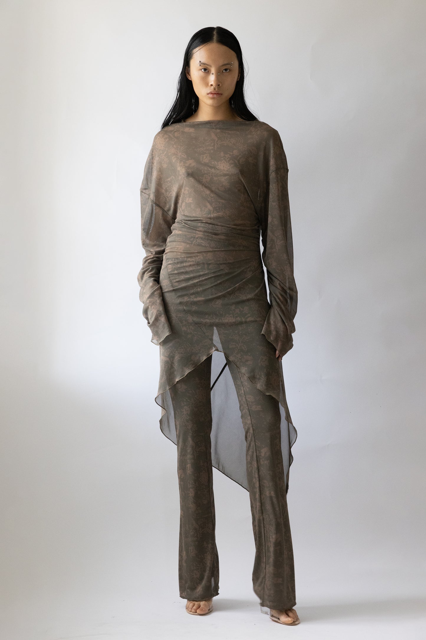 Jade Cropper sheer overlay gray top with elastic gathering draped hem and long sleeves front view on model