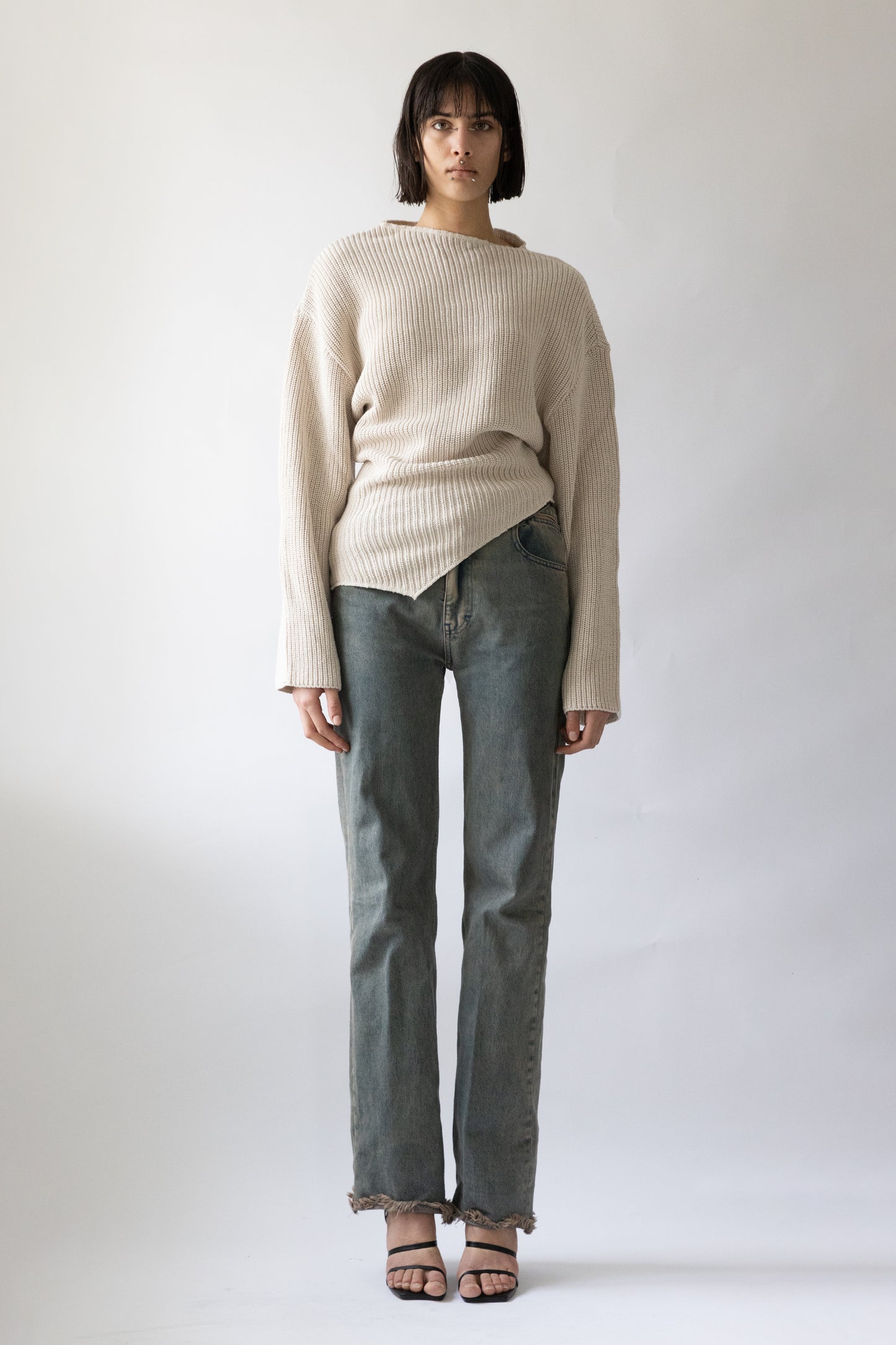 Jade Cropper front view of ribbed beige garment with drop shoulder loose fit and asymmetrical hem