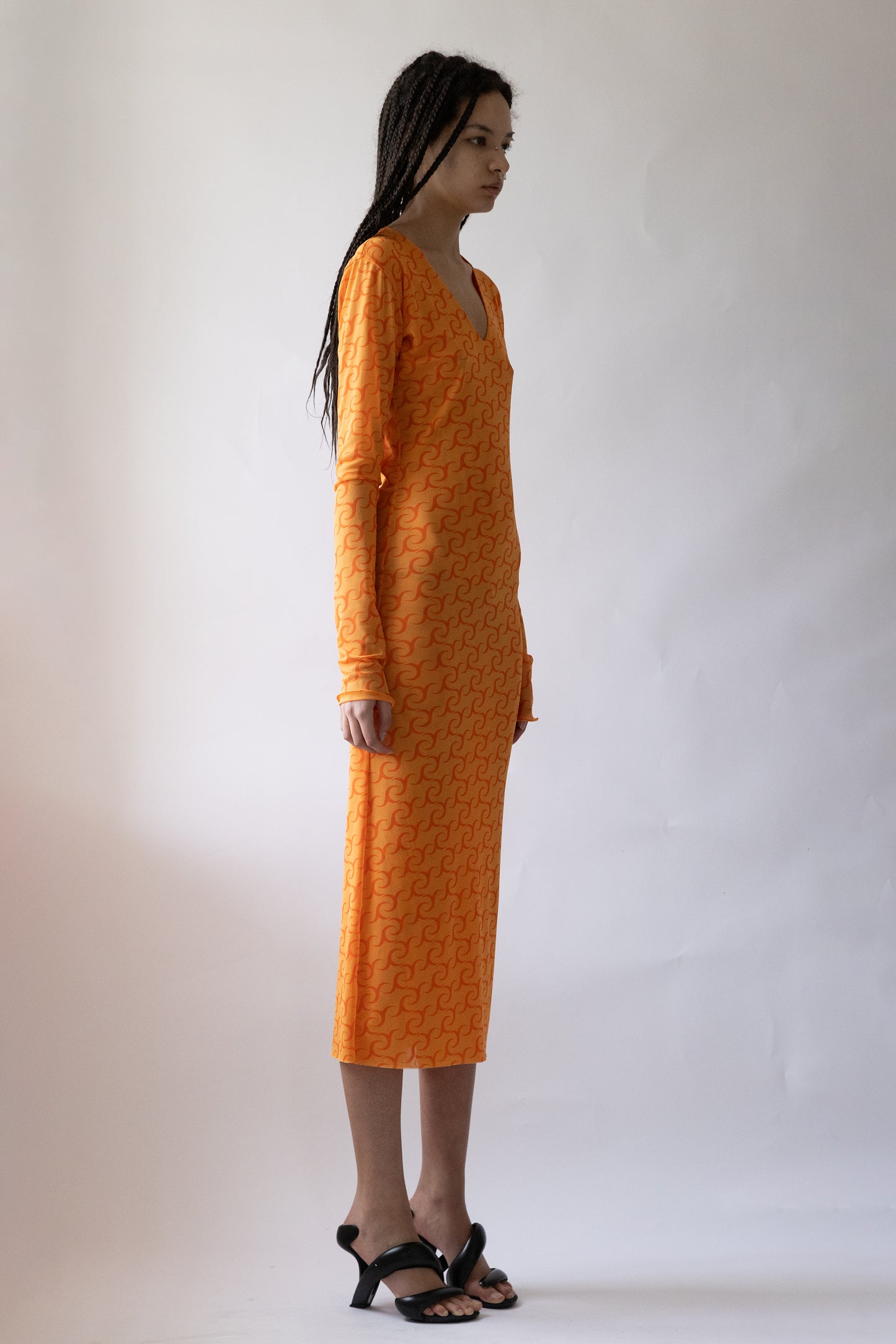 Side view of Jade Cropper JC Logo Dress/Skirt in orange highlights mid-length fit long sleeves v-neck and patterned fabric