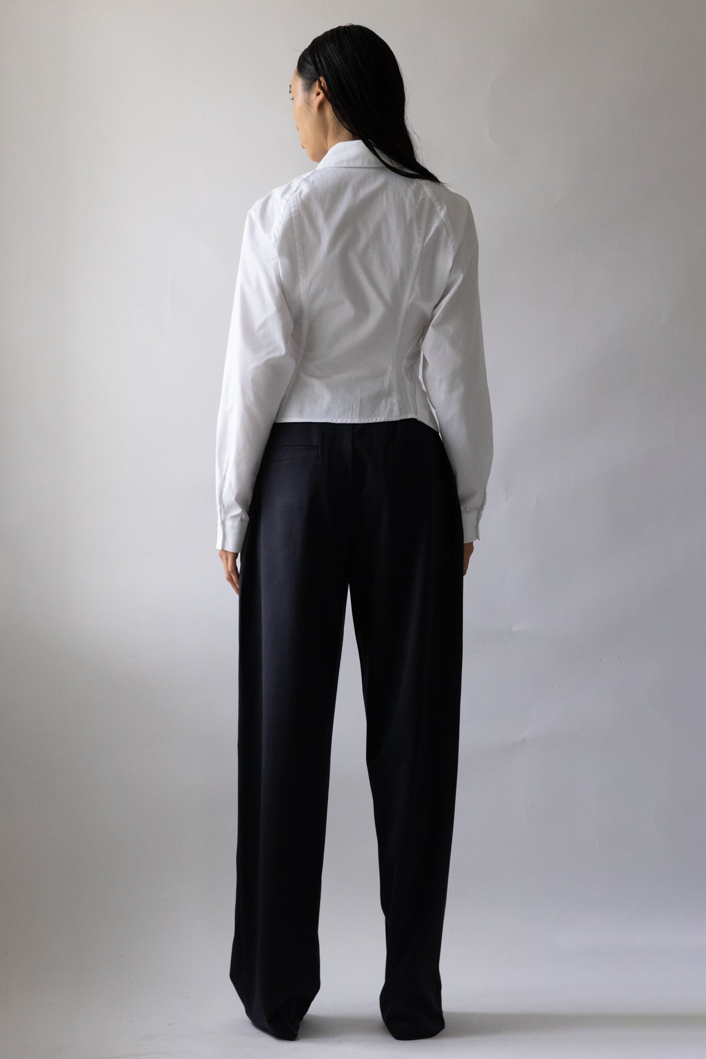Back view of Jade Cropper Asymmetric Shirt White on model with cropped cut button closure long sleeves and collared back