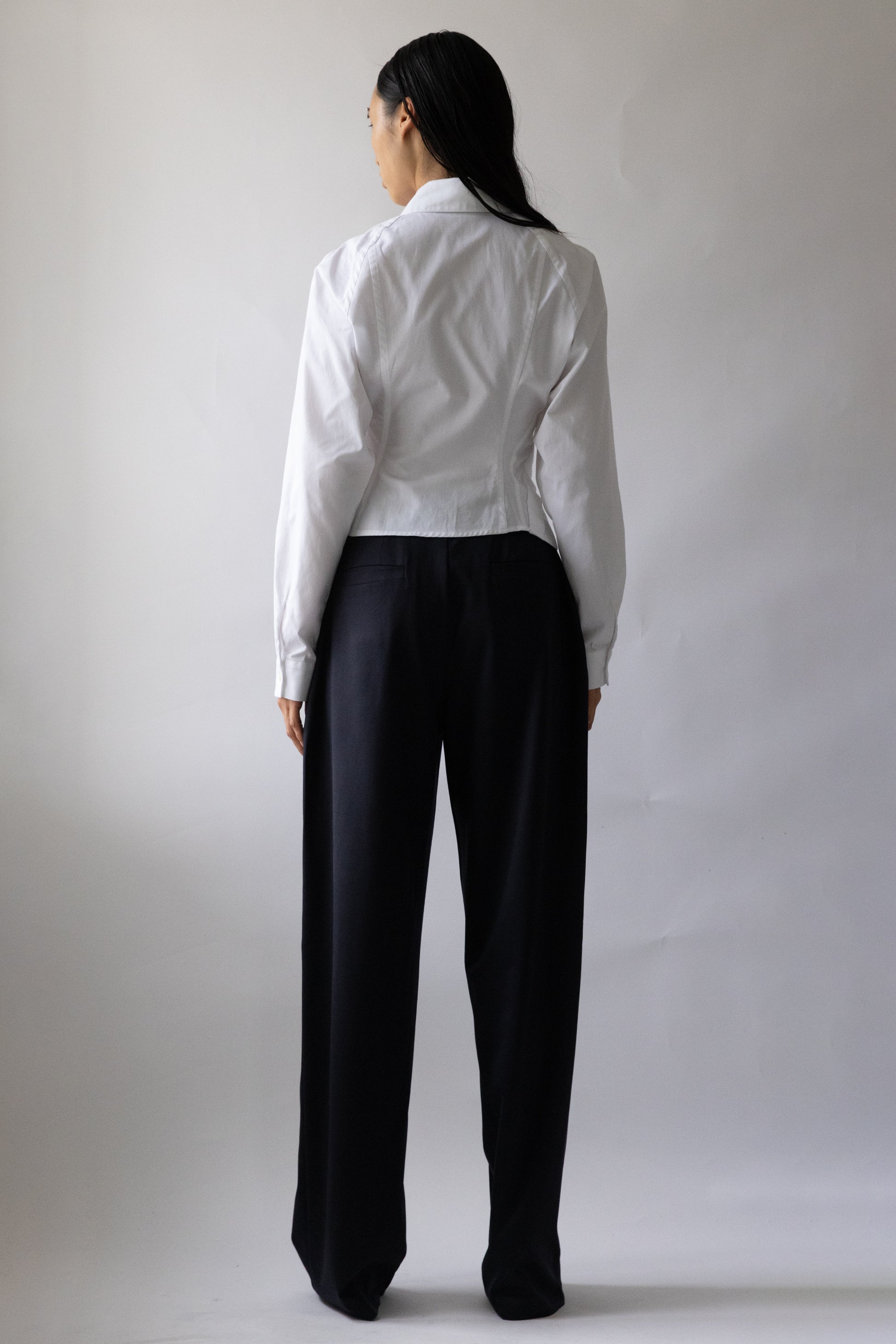 Back view of Jade Cropper Asymmetric Shirt White on model with cropped cut button closure long sleeves and collared back