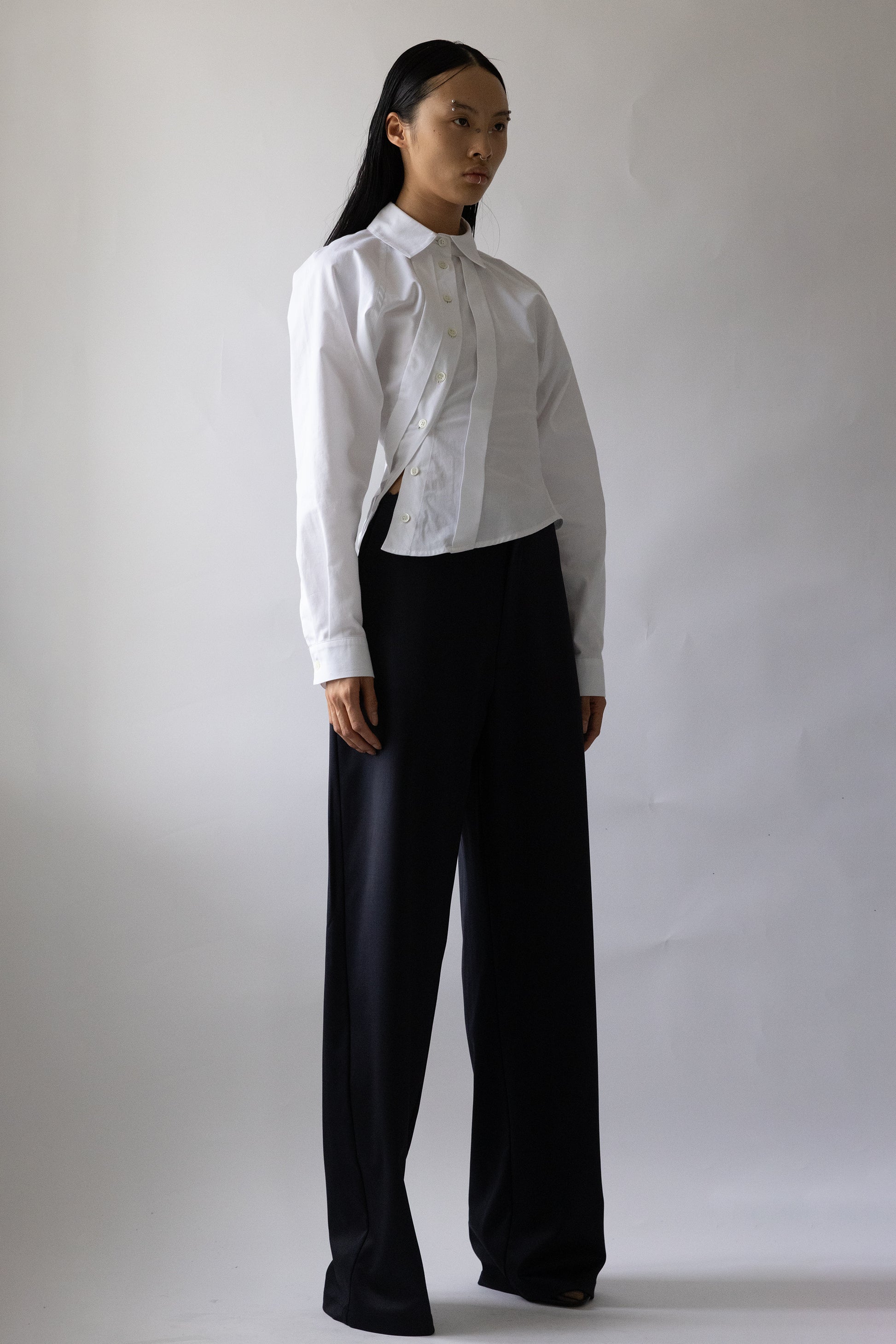 Jade Cropper Asymmetric Shirt White shown front view on model with button closure collared neck long sleeve and side slit