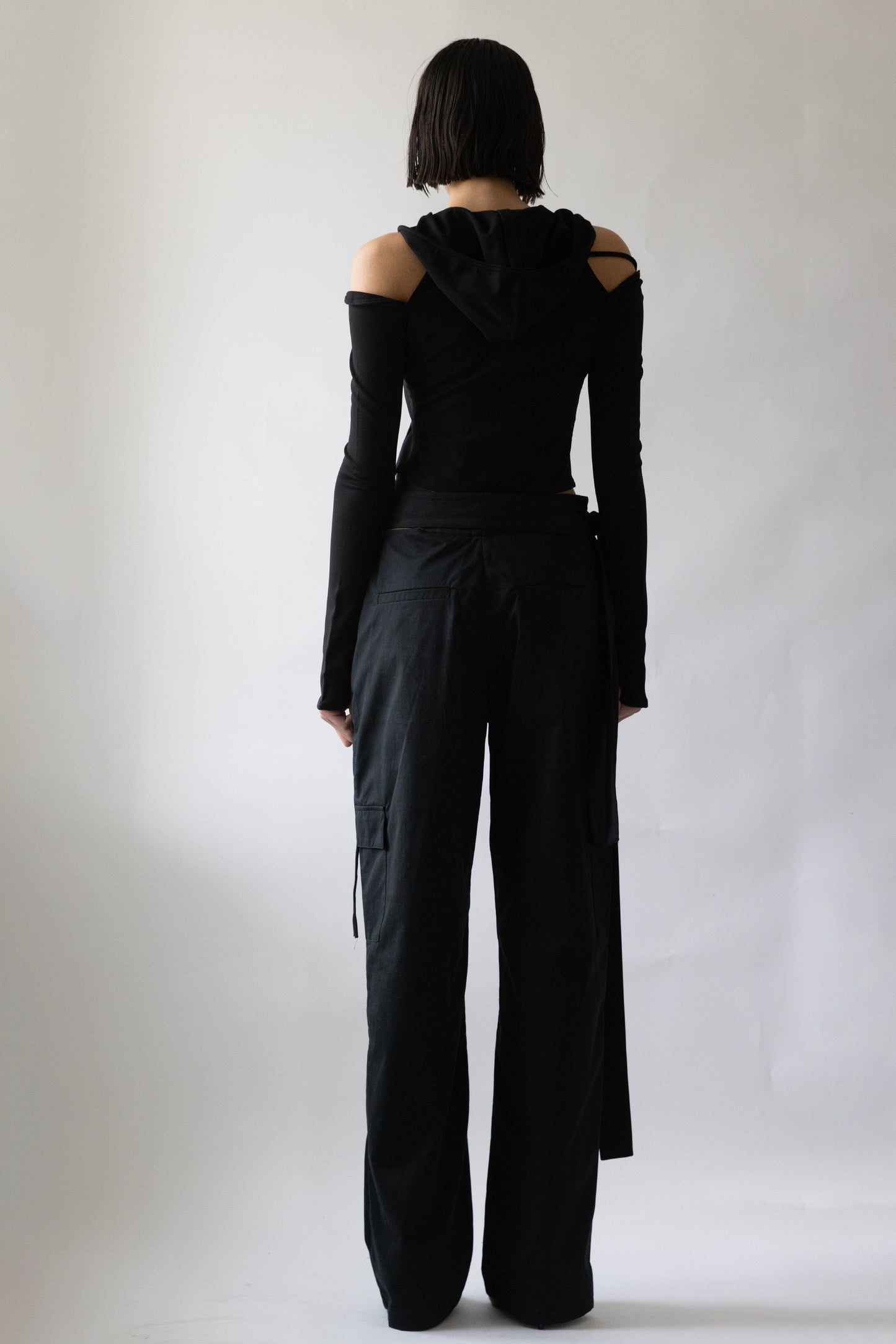 Rear view of black cropped Jade Cropper Hooded Cardigan With Straps with hood, off-shoulder cut, and long sleeves