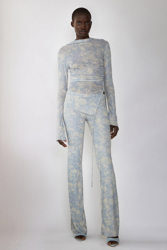 Model wearing Jade Cropper wrap design front view with long sleeves, flared legs and bold print