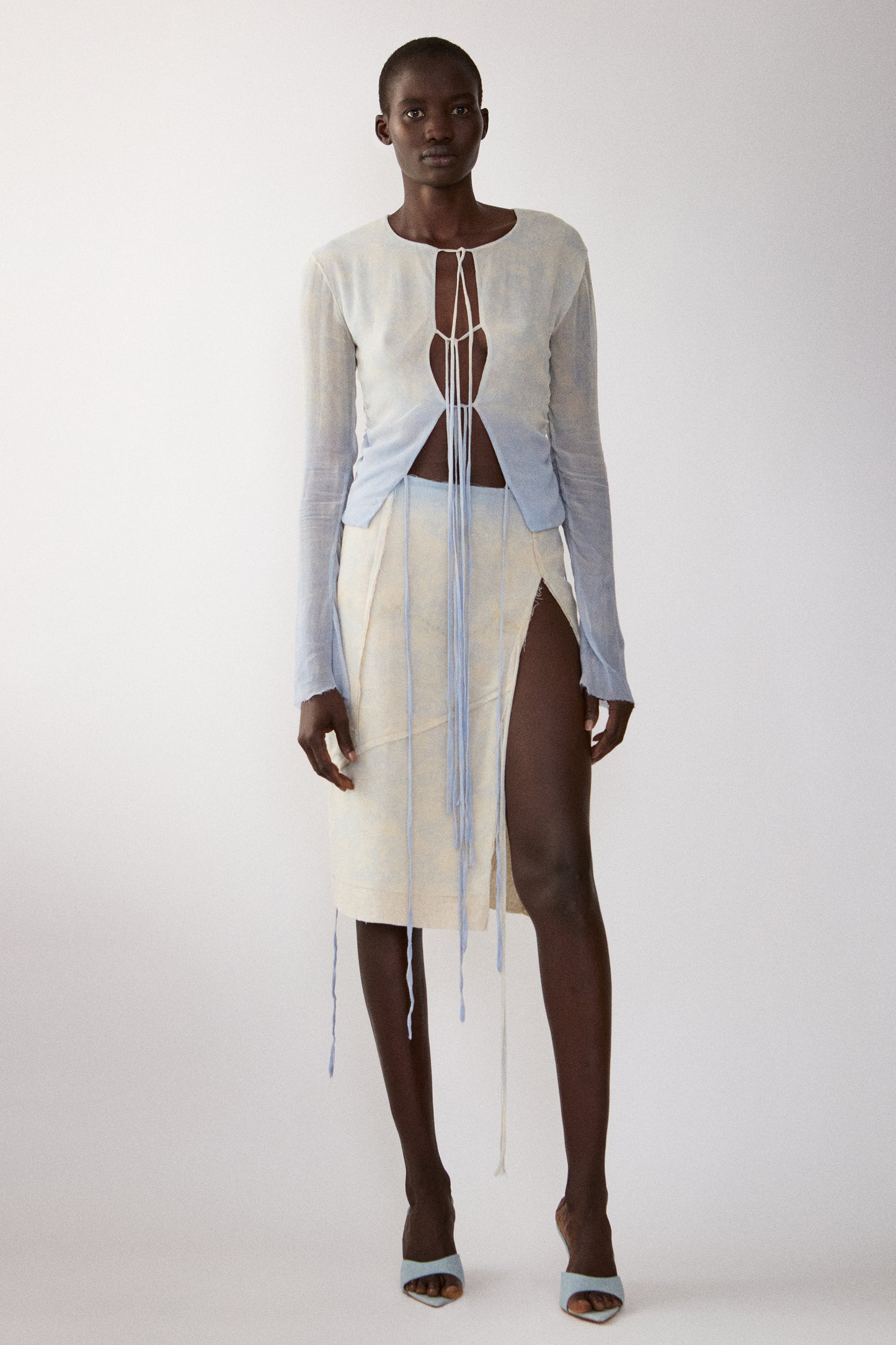 model wearing Jade Cropper Dip-Dye Silk Skirt front view with white sheer fabric long sleeves cut-out and tie detail