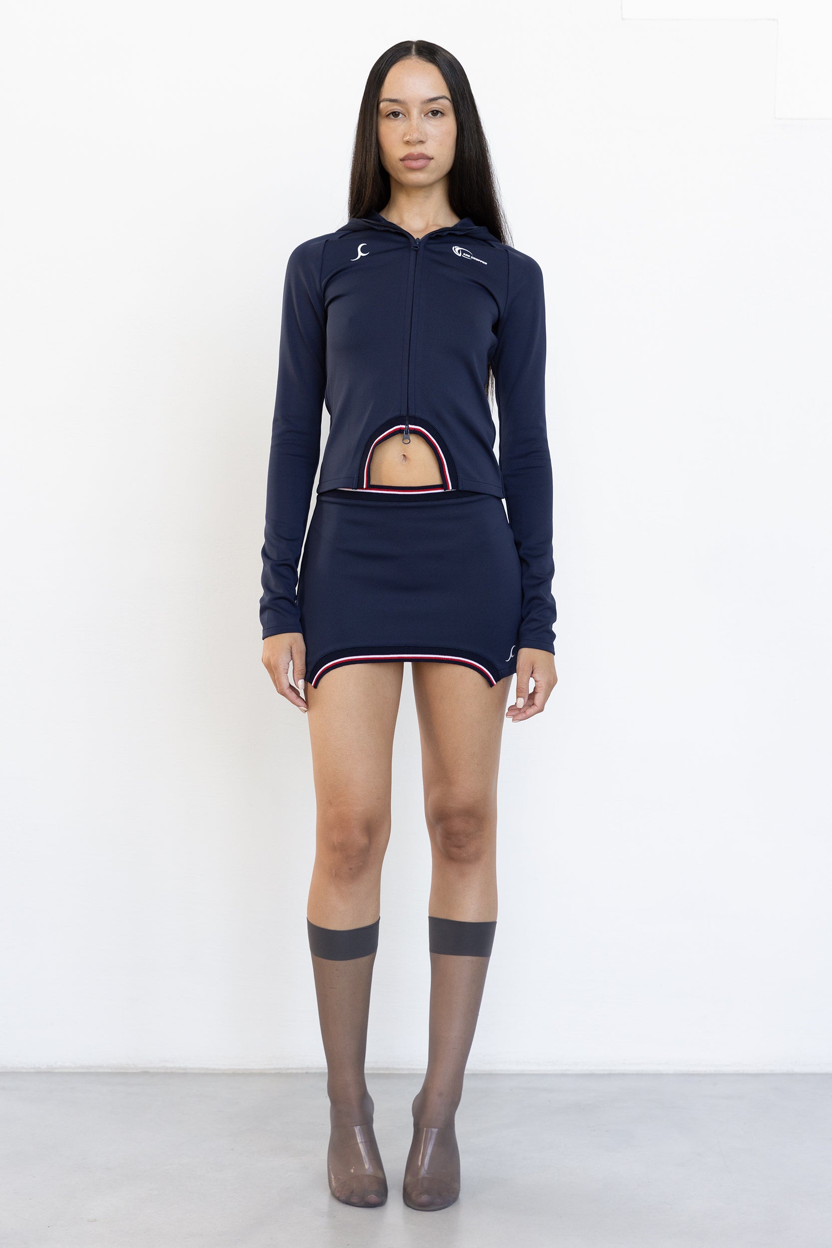 model wears navy hooded top with zipper rib cut-out and contrast piping at front by Jade Cropper Hooded Top With Rib Detail