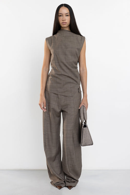 Front view of Jade Cropper asymmetric suit top with open back in brown plaid featuring curved legs and sharp cut