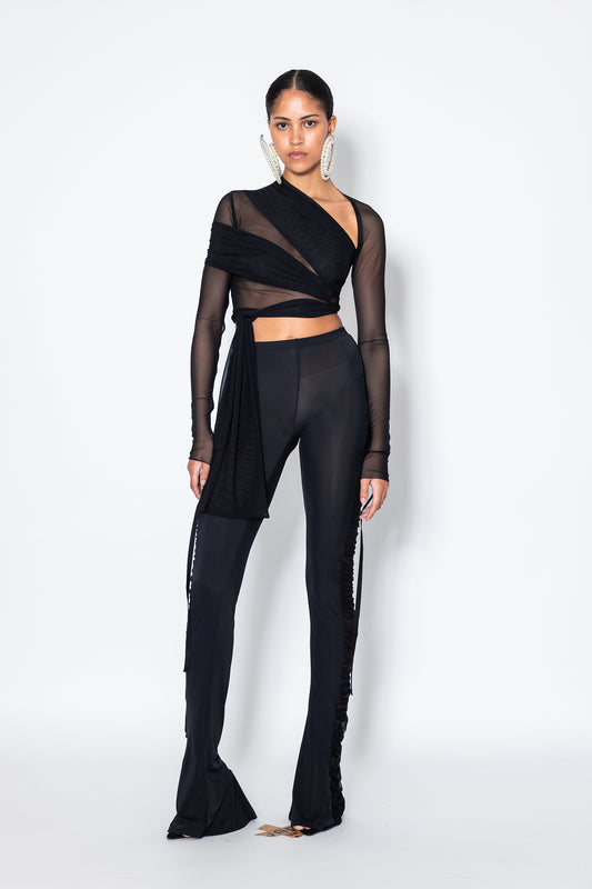 Jade Cropper black mesh wrap top on model front view with long sleeves and asymmetrical hem detail