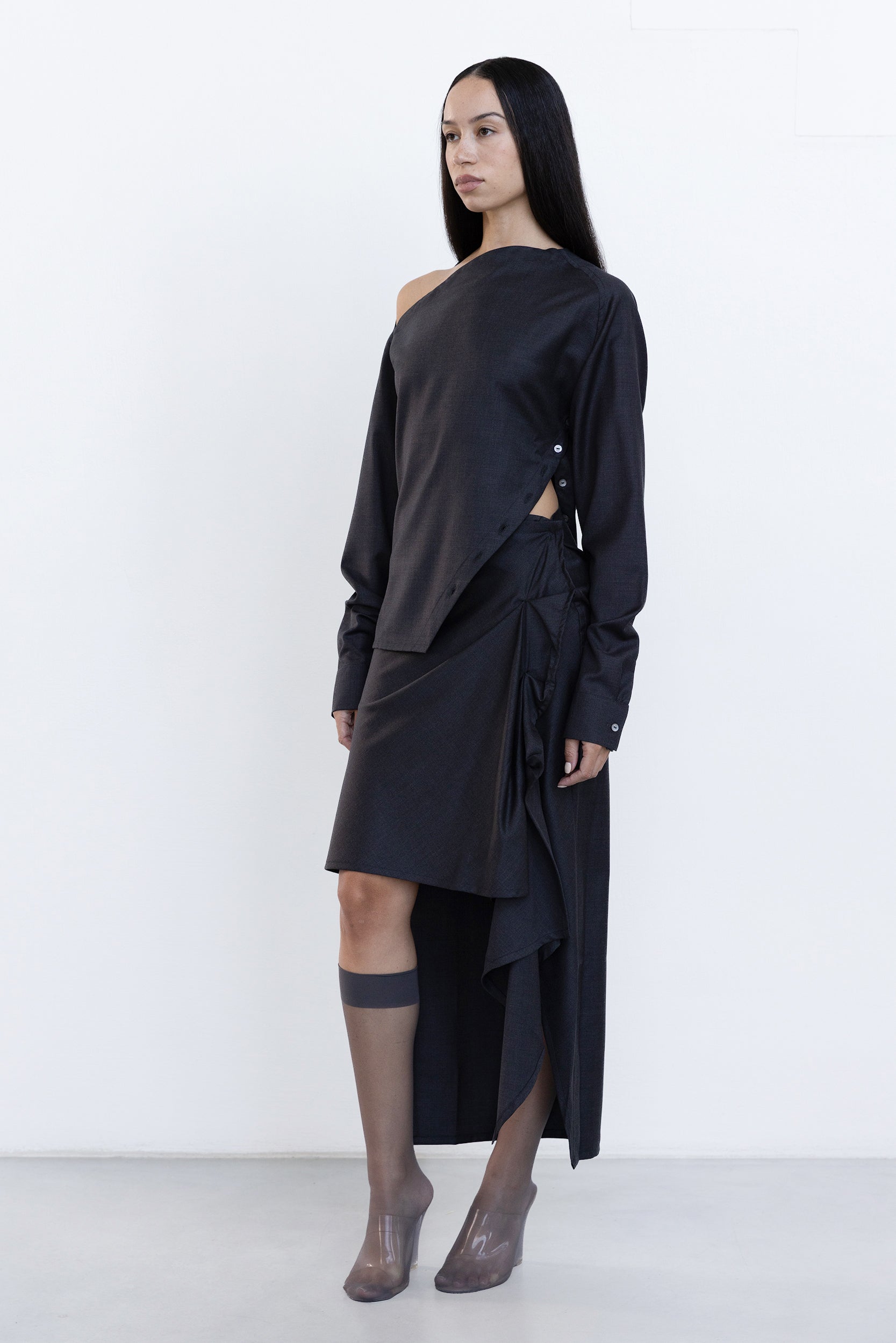 Side view of Jade Cropper Draped Wrap Skirt in gray showing draped hem high slit asymmetrical cut and button details