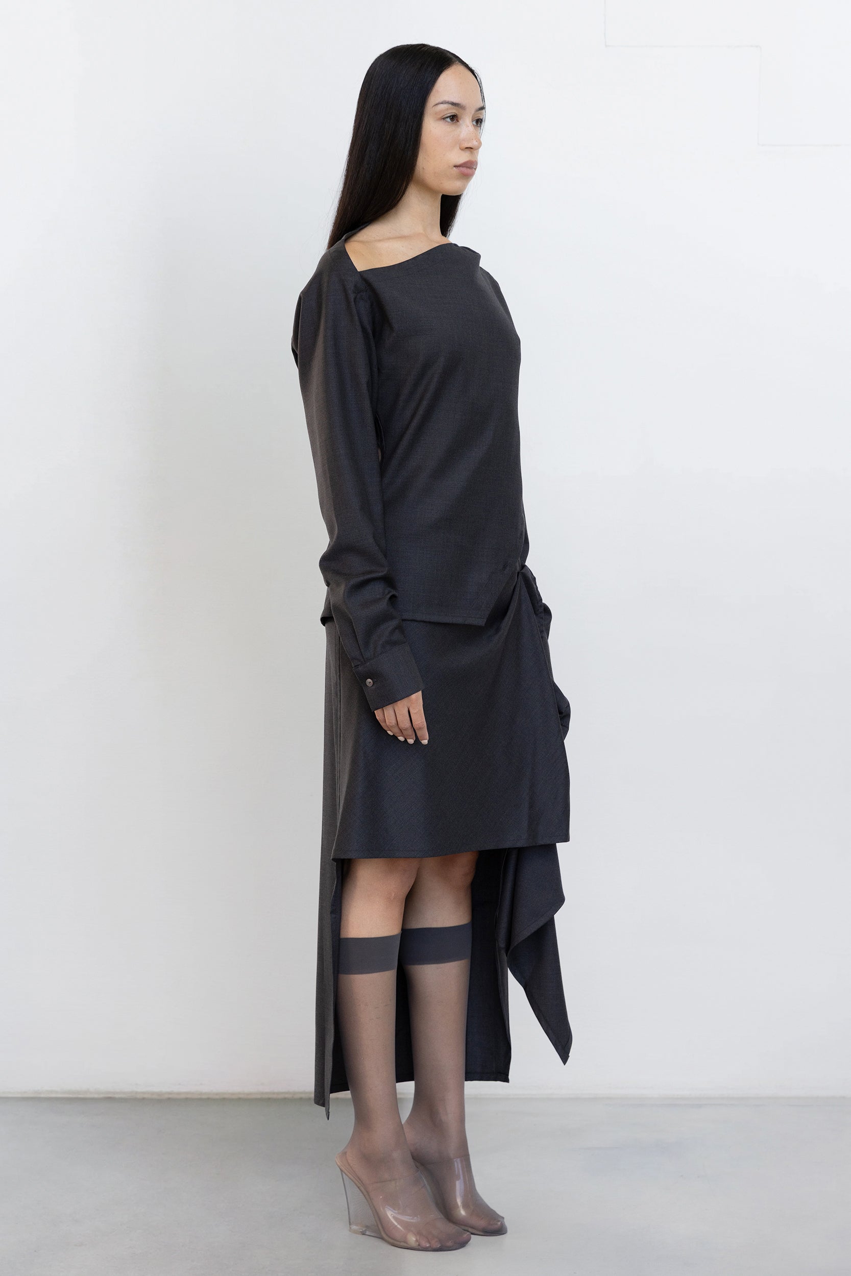 Side view of Jade Cropper Draped Wrap Skirt in gray two-tone fabric with draped hem asymmetrical cut and button detail