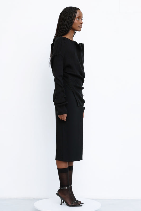 Side view of Jade Cropper ribbed texture black top with long sleeves crew neck and asymmetrical hem