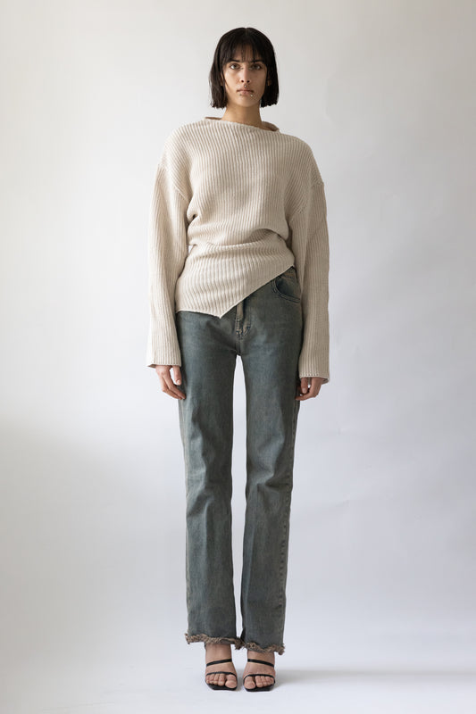 Jade Cropper front view of ribbed beige garment with drop shoulder loose fit and asymmetrical hem