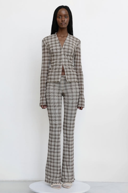 Model wears Jade Cropper garment with gray plaid pattern long sleeves v-neck and scalloped hem front view