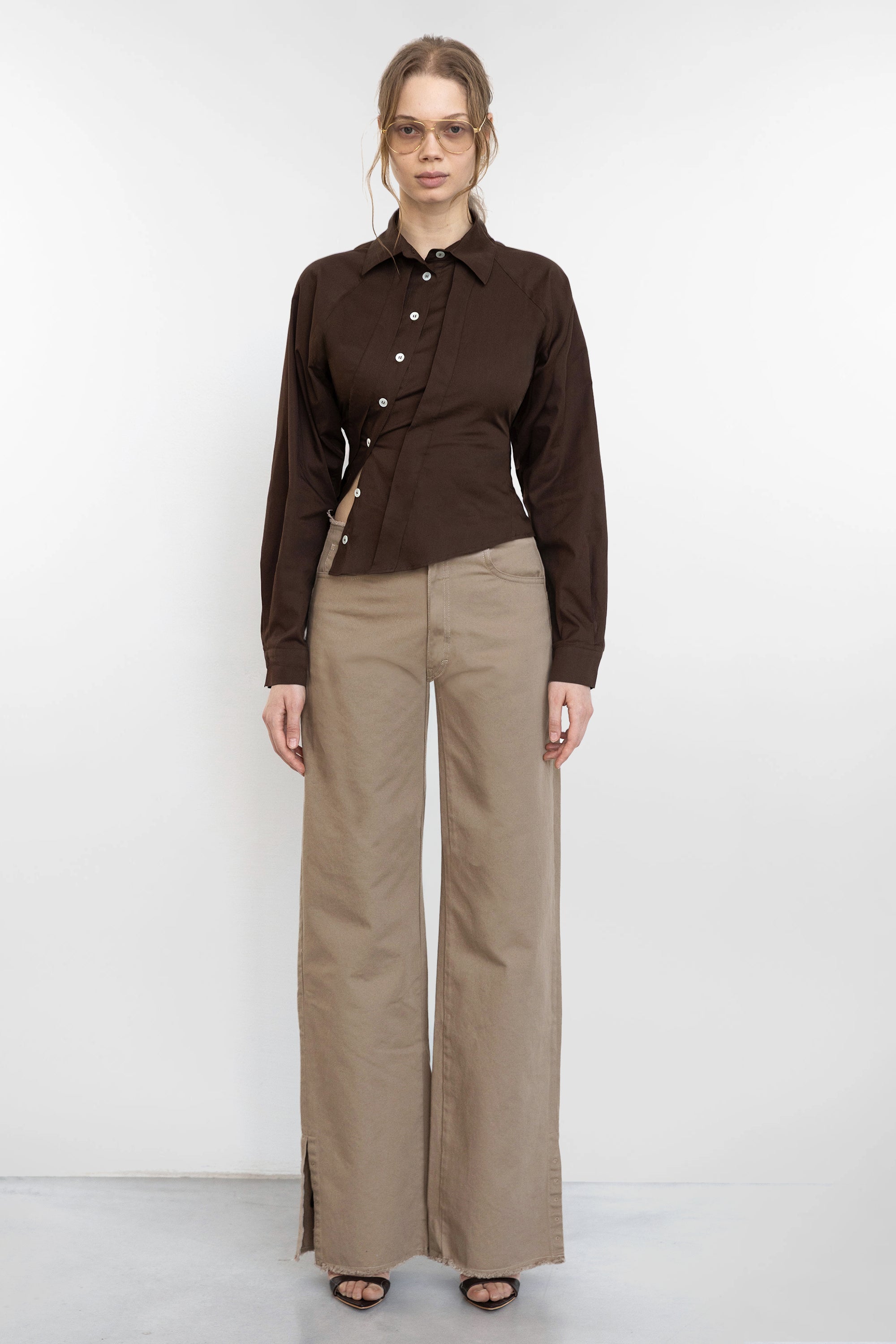Jade Cropper brown garment with button closure, collar, long sleeves and asymmetrical cut front on model