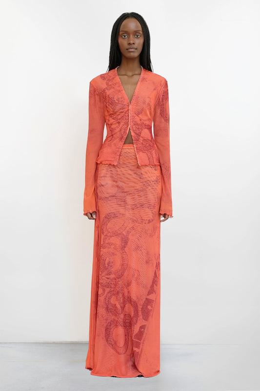 Model wears Jade Cropper long-length high waist skirt with slit and intricate pattern front view
